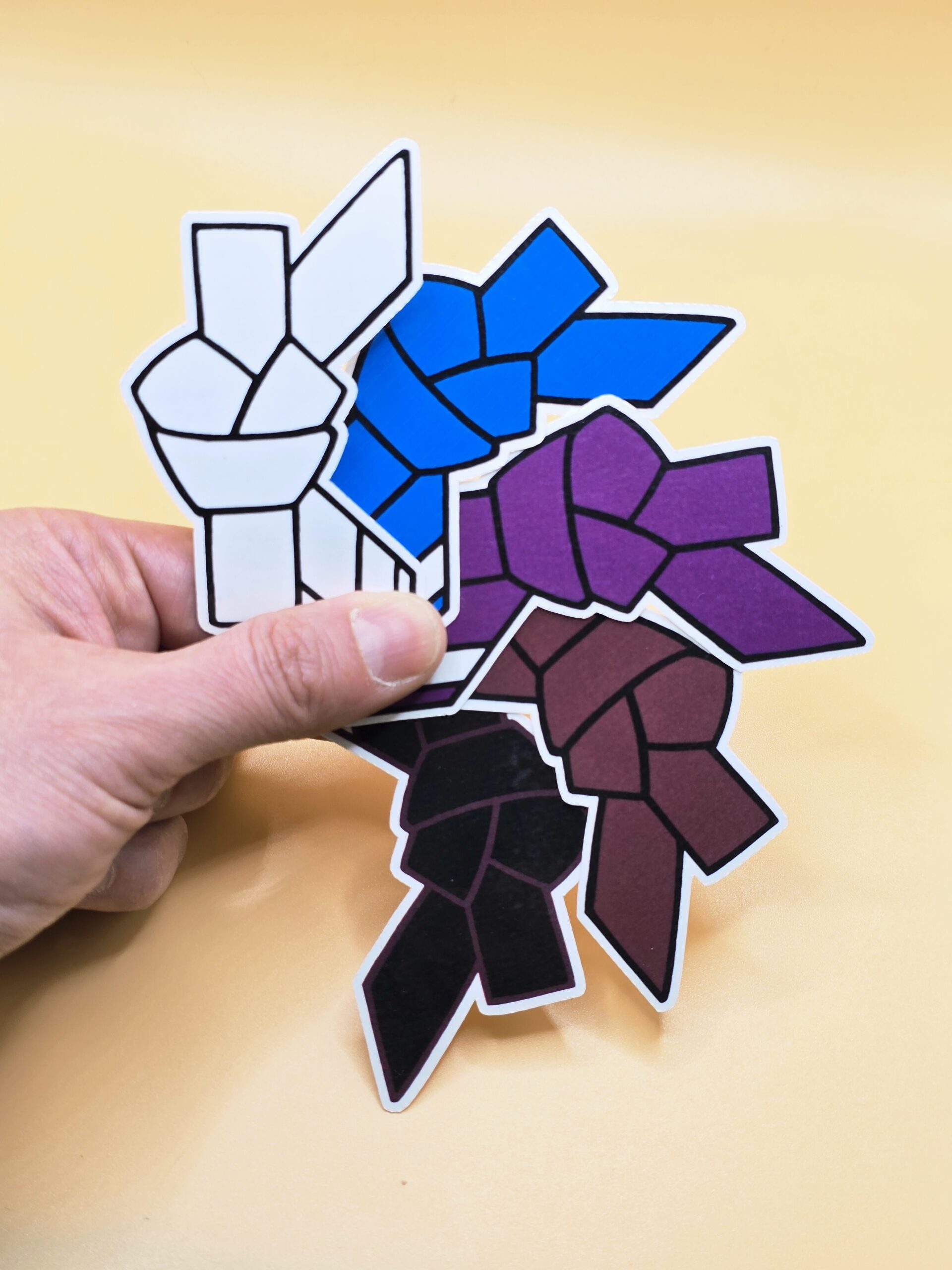 Ranked Jiu-Jitsu stickers fanned in order from top to bottom in white, blue, purple, brown, and black